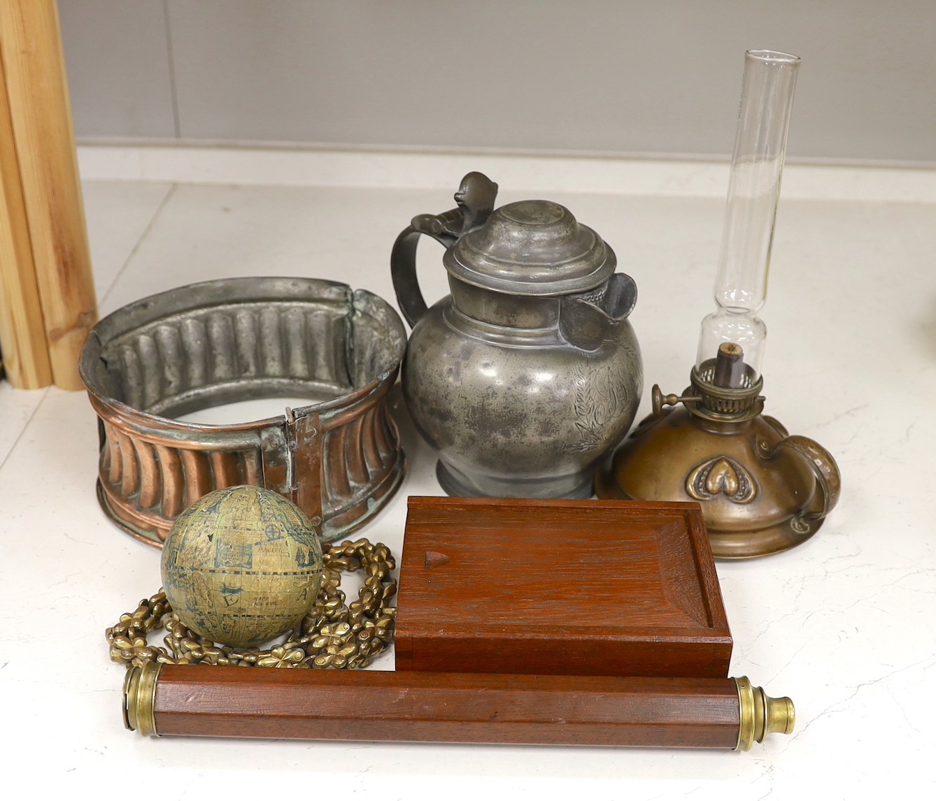 An unusual Victorian copper pie-mould, teak cased set of Bezique scorers, a brass link chain, a 19th century pewter pitcher, an Art Nouveau oil lamp, and two other items